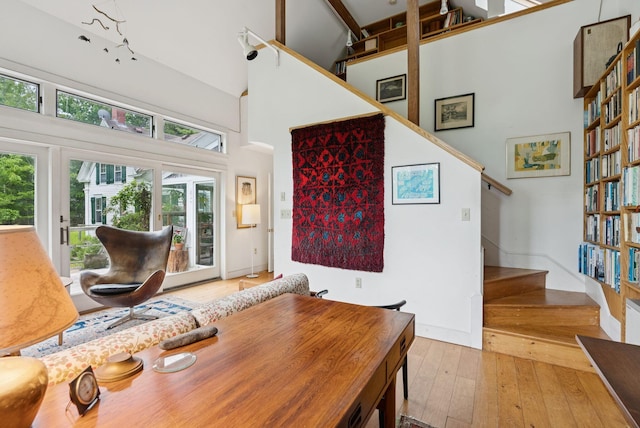 168 S Rd, Chebeague Island, ME 04017 - dining area featuring a towering ceiling, stairs, and wood-type flooring