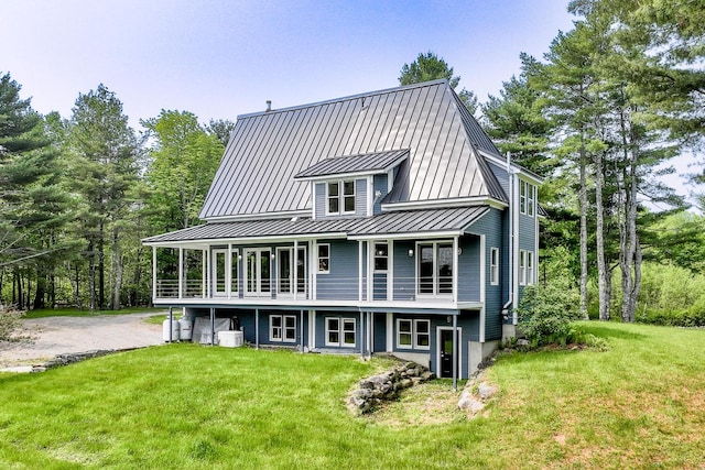 60 Cobb Rd, Belfast, ME 04915 - rear view of house featuring a standing seam roof, a lawn, and metal roof
