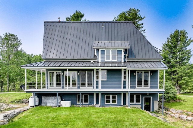60 Cobb Rd, Belfast, ME 04915 - back of property featuring a standing seam roof, a lawn, and metal roof