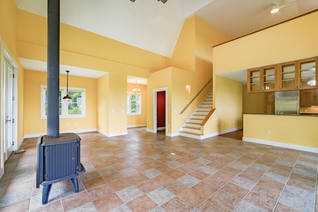 60 Cobb Rd, Belfast, ME 04915 - entrance foyer with a wood stove, high vaulted ceiling, baseboards, stairway, and a ceiling fan