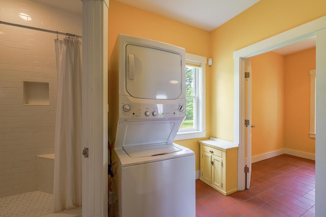 60 Cobb Rd, Belfast, ME 04915 - laundry area featuring stacked washer / drying machine and dark tile patterned floors