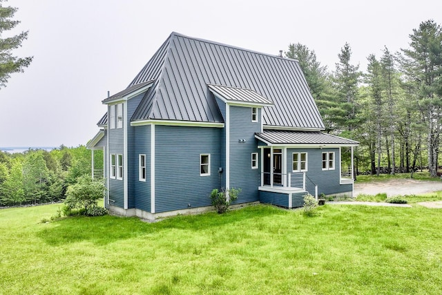 60 Cobb Rd, Belfast, ME 04915 - rear view of property with a lawn and a standing seam roof