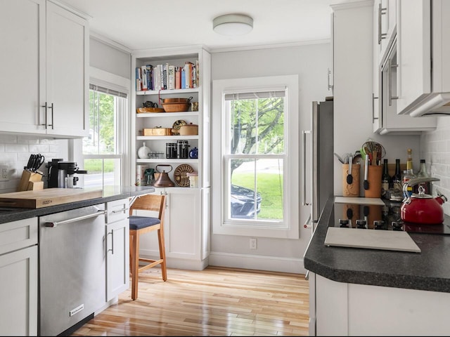 2593 Bristol Rd, Bristol, ME 04554 - kitchen featuring stainless steel dishwasher, healthy amount of natural light, decorative backsplash, and crown molding