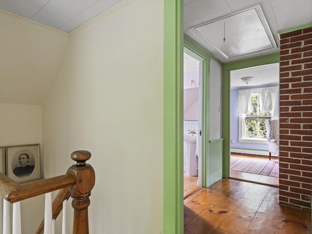 2593 Bristol Rd, Bristol, ME 04554 - hall with attic access, a baseboard heating unit, an upstairs landing, hardwood / wood-style flooring, and crown molding