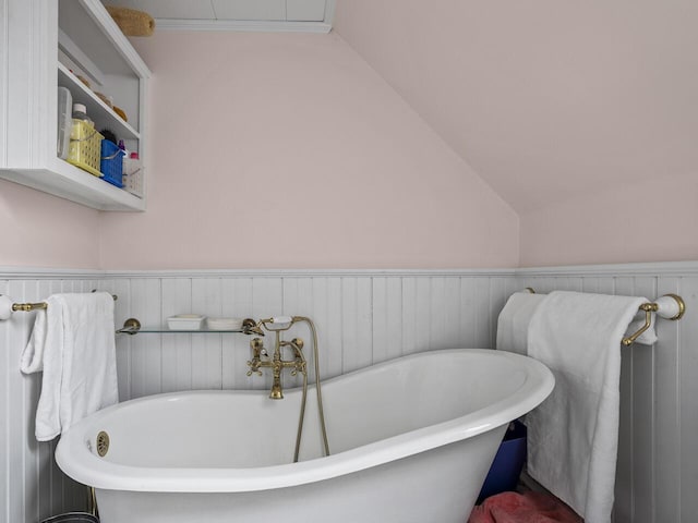 2593 Bristol Rd, Bristol, ME 04554 - bathroom featuring a soaking tub, wainscoting, and lofted ceiling