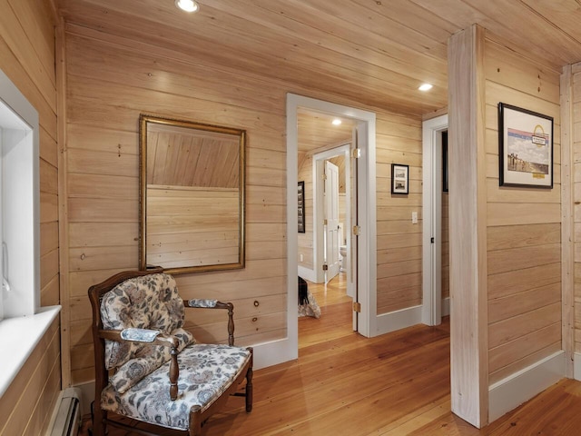 2593 Bristol Rd, Bristol, ME 04554 - living area with baseboard heating, wooden walls, light wood-type flooring, and recessed lighting