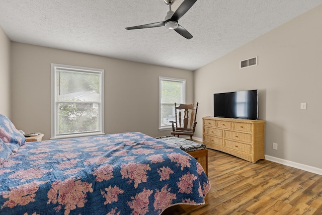 7 Bobcat Ln Unit 7, Berwick, ME 03901 - bedroom featuring wood finished floors, a textured ceiling, vaulted ceiling, baseboards, and a ceiling fan