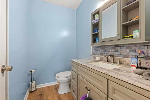 7 Bobcat Ln Unit 7, Berwick, ME 03901 - bathroom with vanity, toilet, wood finished floors, tasteful backsplash, and baseboards
