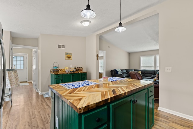 7 Bobcat Ln Unit 7, Berwick, ME 03901 - kitchen with green cabinets, butcher block countertops, light wood finished floors, healthy amount of natural light, and a textured ceiling