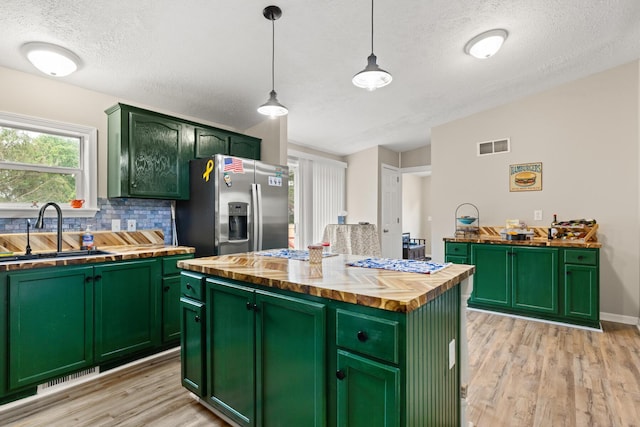 7 Bobcat Ln Unit 7, Berwick, ME 03901 - kitchen featuring butcher block counters, green cabinetry, a sink, stainless steel fridge with ice dispenser, and light wood-style flooring
