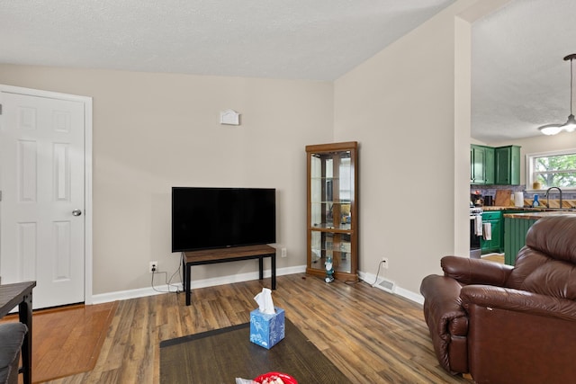 7 Bobcat Ln Unit 7, Berwick, ME 03901 - living room with wood finished floors, baseboards, and a textured ceiling