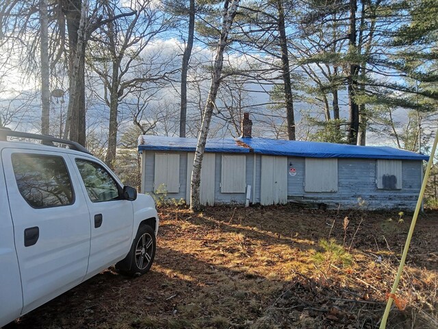 915 Augusta Rd, Belgrade, ME 04917 - view of side of home featuring a chimney