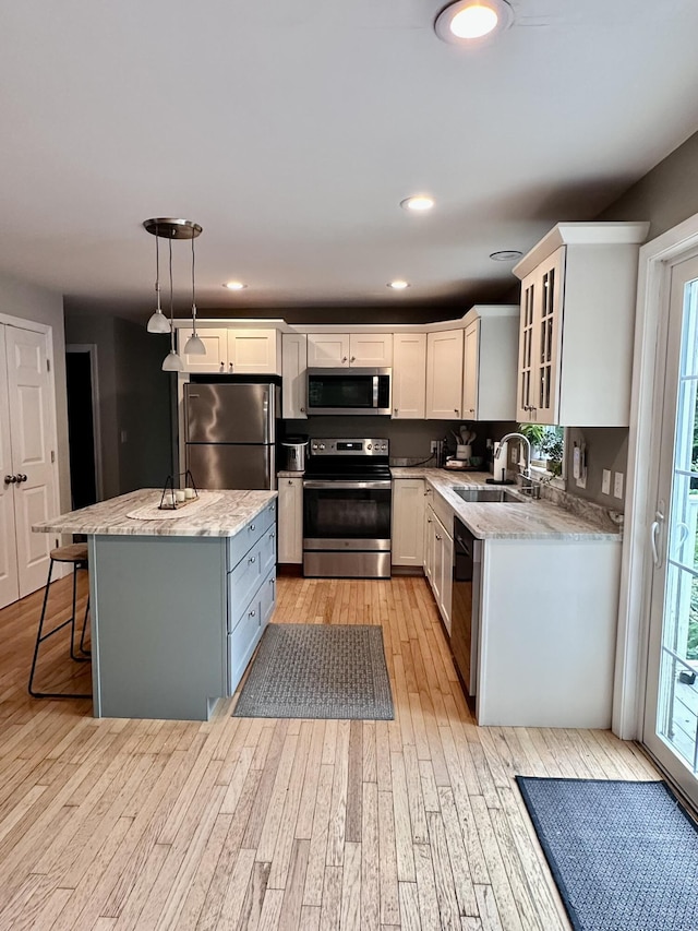 35 Knight Dr, Naples, ME 04055 - kitchen featuring stainless steel appliances, light wood finished floors, a kitchen island, healthy amount of natural light, and recessed lighting