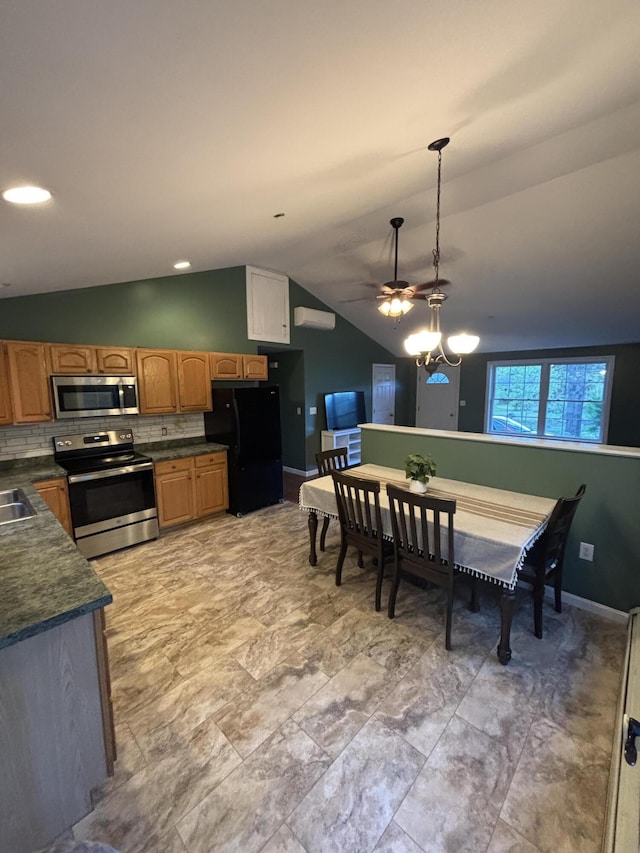 69 Frasier Ln, Acton, ME 04001 - kitchen featuring stainless steel appliances, vaulted ceiling, dark countertops, ceiling fan, and pendant lighting