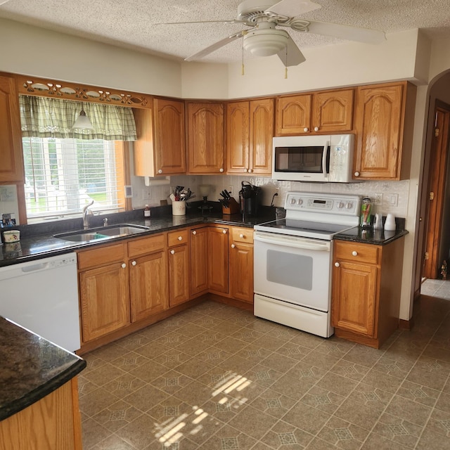 116 Main Rd, Passadumkeag, ME 04475 - kitchen with white appliances, a sink, brown cabinets, and a textured ceiling