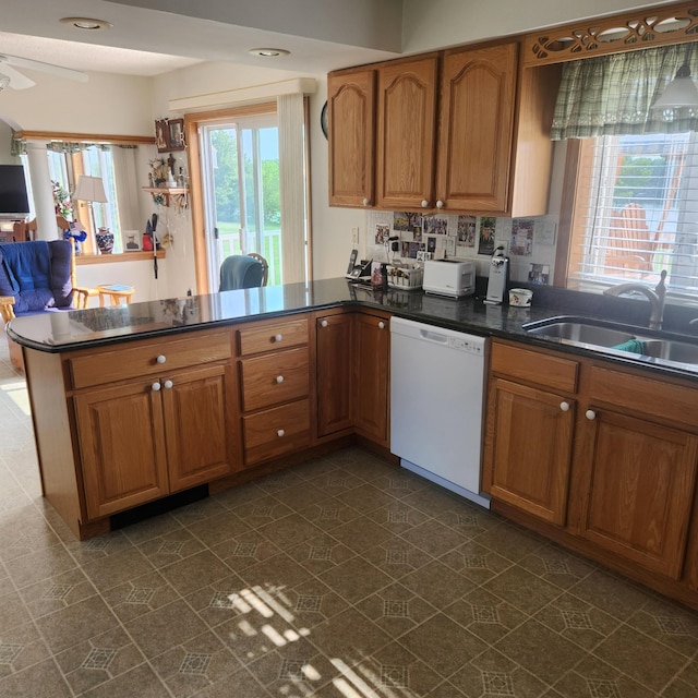 116 Main Rd, Passadumkeag, ME 04475 - kitchen with white dishwasher, a sink, a peninsula, and brown cabinetry