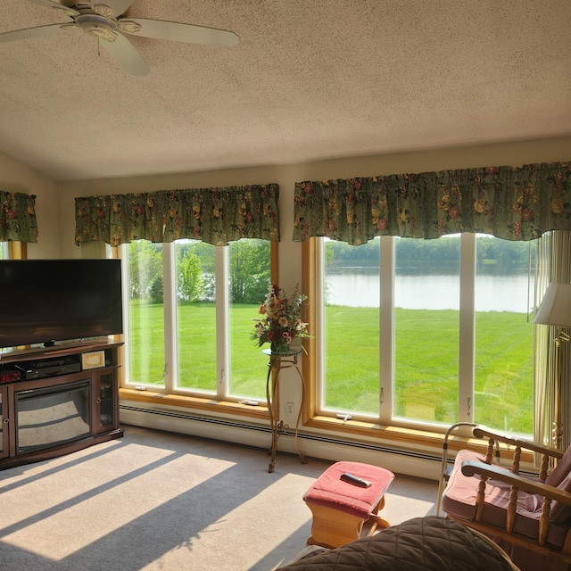 116 Main Rd, Passadumkeag, ME 04475 - living room featuring a textured ceiling, a water view, ceiling fan, carpet floors, and a baseboard heating unit