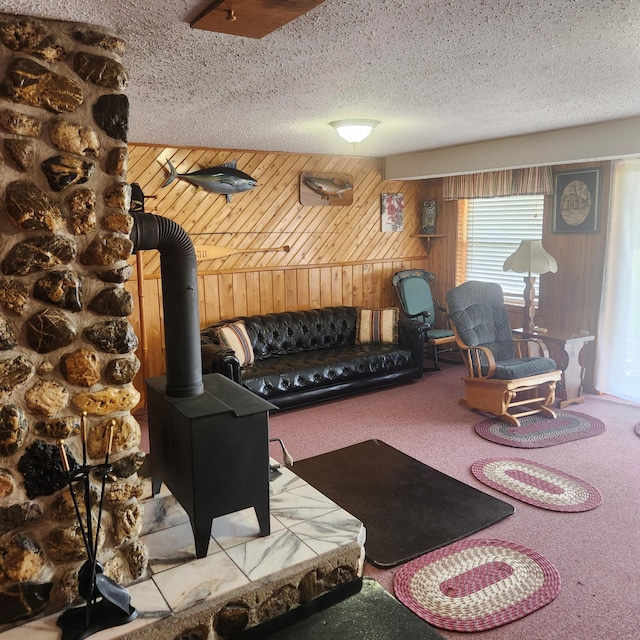 116 Main Rd, Passadumkeag, ME 04475 - workout area featuring wooden walls, carpet floors, a wood stove, and a textured ceiling