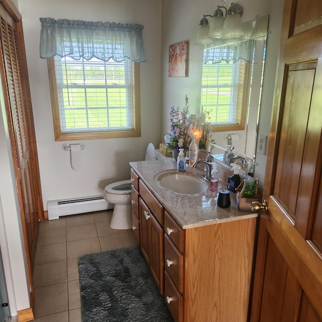 116 Main Rd, Passadumkeag, ME 04475 - bathroom with a baseboard radiator, vanity, toilet, and tile patterned floors