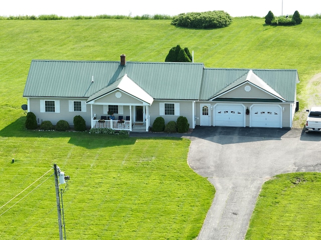 116 Main Rd, Passadumkeag, ME 04475 - view of front of home featuring a porch, a garage, driveway, a chimney, and metal roof
