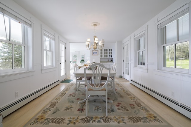 55 Ferry Rd, Swans Island, ME 04685 - dining room with baseboard heating, healthy amount of natural light, and light wood finished floors