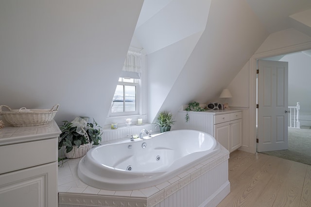 55 Ferry Rd, Swans Island, ME 04685 - full bath featuring lofted ceiling, wood finished floors, and a jetted tub