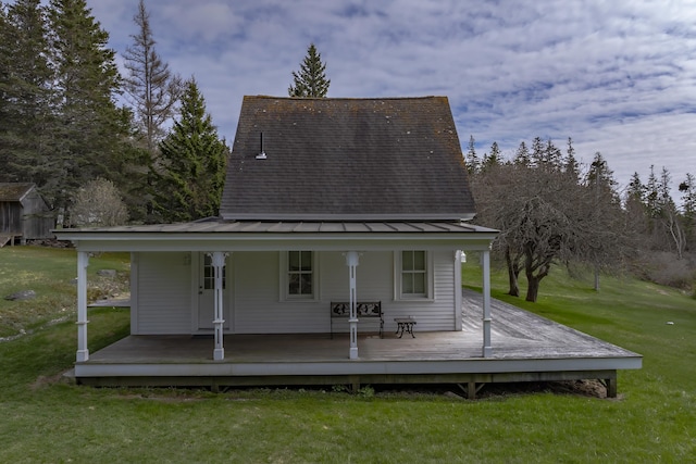 55 Ferry Rd, Swans Island, ME 04685 - rear view of property featuring a standing seam roof, metal roof, and a lawn
