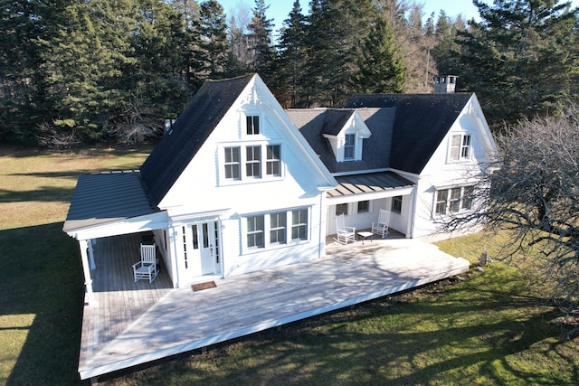 55 Ferry Rd, Swans Island, ME 04685 - back of property featuring a yard, metal roof, a standing seam roof, and a wooden deck