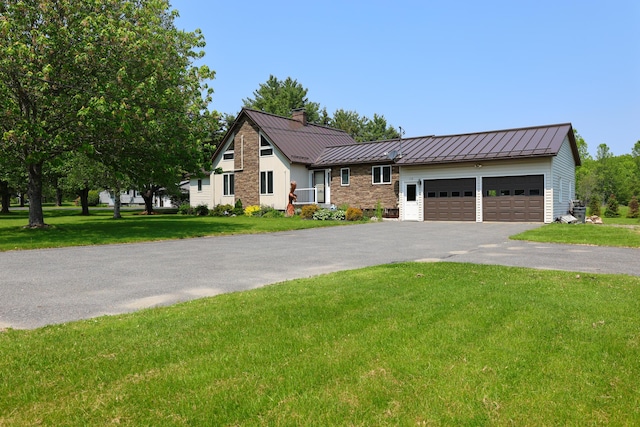 178 Clinton Ave, Winslow, ME 04901 - view of front of home with a standing seam roof, metal roof, driveway, and a chimney