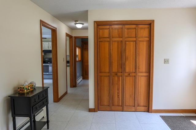 178 Clinton Ave, Winslow, ME 04901 - hall with a baseboard heating unit, baseboards, and light tile patterned floors