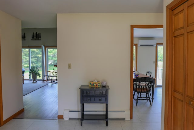 178 Clinton Ave, Winslow, ME 04901 - hall with a wall unit AC, a baseboard heating unit, baseboards, and light tile patterned floors