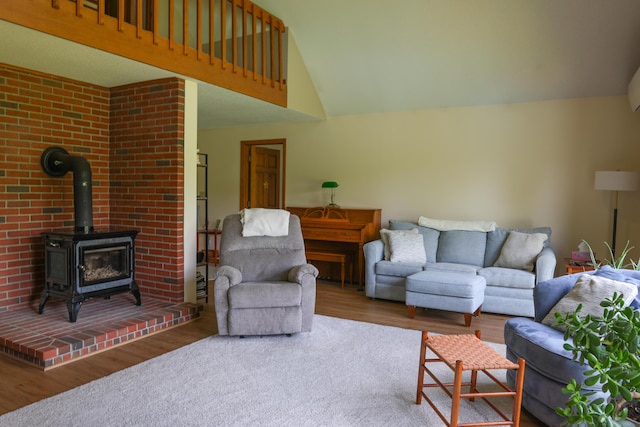 178 Clinton Ave, Winslow, ME 04901 - living area featuring wood finished floors, a wood stove, and vaulted ceiling