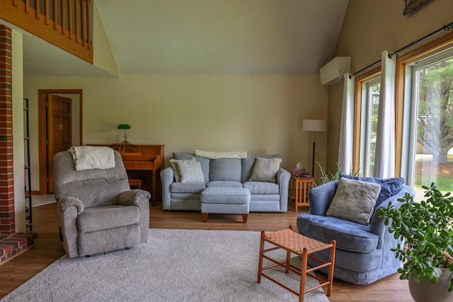 178 Clinton Ave, Winslow, ME 04901 - living area featuring lofted ceiling, an AC wall unit, and wood finished floors