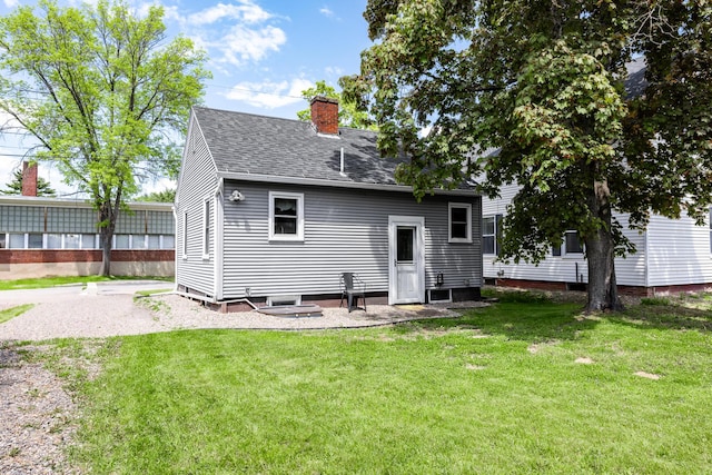 32 Carroll St, Old Town, ME 04468 - back of property featuring a chimney, a shingled roof, and a lawn