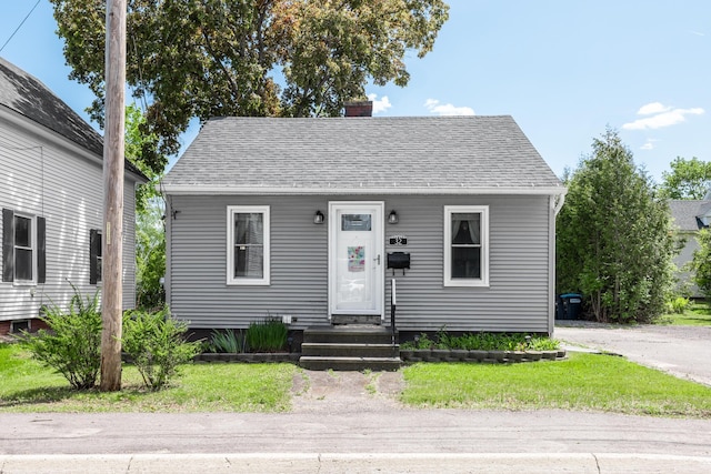 32 Carroll St, Old Town, ME 04468 - view of front facade featuring a chimney, a front lawn, and roof with shingles