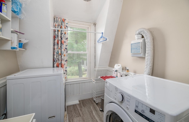 29 Zions Hill Rd, Dexter, ME 04930 - washroom featuring washing machine and dryer, a wainscoted wall, wood finished floors, and healthy amount of natural light