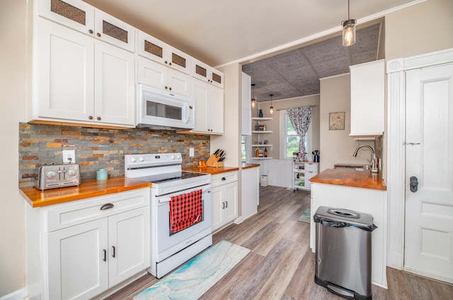 29 Zions Hill Rd, Dexter, ME 04930 - kitchen featuring white appliances, butcher block counters, decorative backsplash, and an ornate ceiling