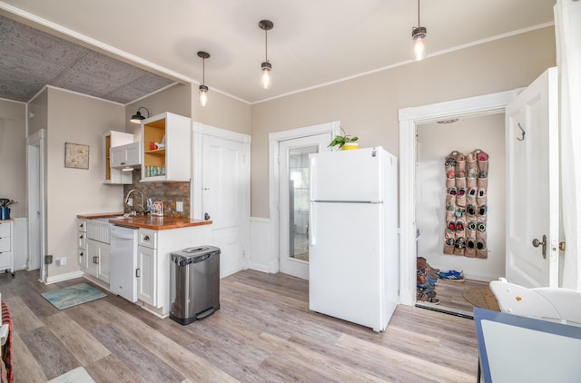 29 Zions Hill Rd, Dexter, ME 04930 - kitchen featuring white appliances, butcher block counters, light wood-style flooring, white cabinets, and decorative backsplash
