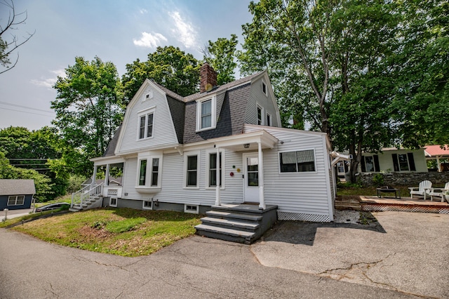29 Zions Hill Rd, Dexter, ME 04930 - dutch colonial featuring a gambrel roof, a shingled roof, a chimney, and a wooden deck