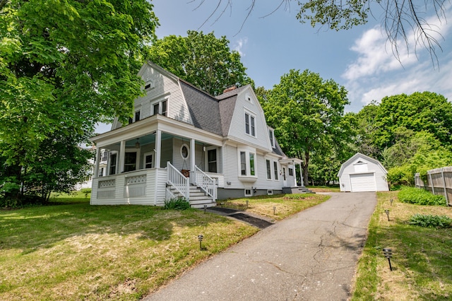 29 Zions Hill Rd, Dexter, ME 04930 - dutch colonial with an outdoor structure, a gambrel roof, a porch, a detached garage, and a front yard