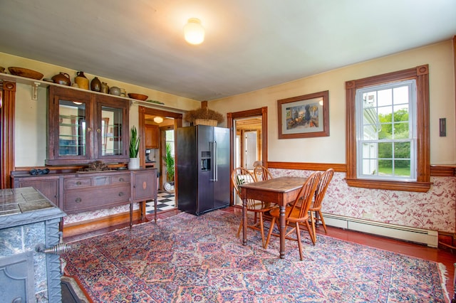 511 Main Rd, Phippsburg, ME 04562 - dining space featuring a baseboard heating unit, wainscoting, and wood finished floors