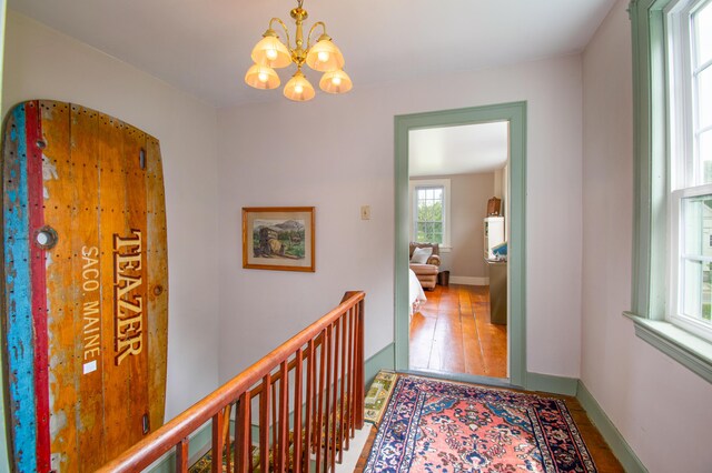 511 Main Rd, Phippsburg, ME 04562 - corridor with a chandelier, an upstairs landing, and wood finished floors