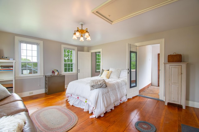 511 Main Rd, Phippsburg, ME 04562 - bedroom featuring hardwood / wood-style flooring and a chandelier