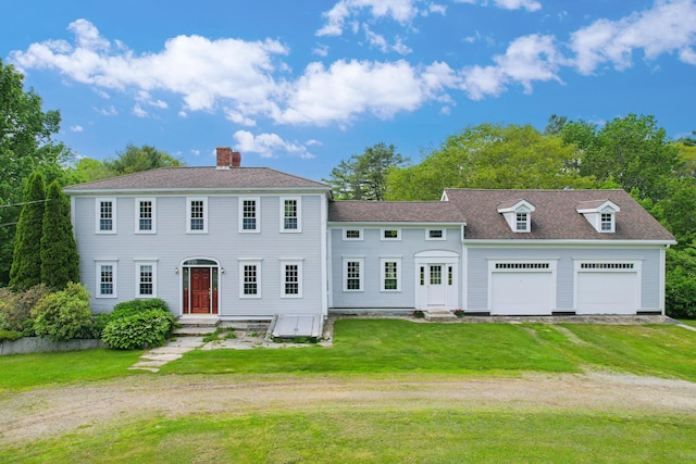 511 Main Rd, Phippsburg, ME 04562 - colonial inspired home featuring dirt driveway, a chimney, a front yard, a garage, and a shingled roof