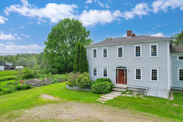 511 Main Rd, Phippsburg, ME 04562 - colonial inspired home featuring a chimney, a front yard, a garden, and roof with shingles