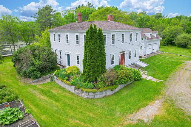 511 Main Rd, Phippsburg, ME 04562 - colonial-style house with a chimney, a front yard, and a garage