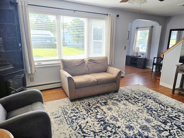 351 Maple St, Bangor, ME 04401 - living area featuring a baseboard heating unit, wood finished floors, a ceiling fan, and baseboards