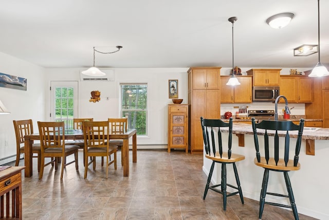 31 Knight Way N, Yarmouth, ME 04097 - kitchen with appliances with stainless steel finishes, a wall mounted AC, a breakfast bar, decorative light fixtures, and light stone counters