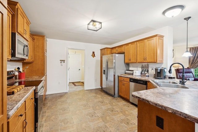 31 Knight Way N, Yarmouth, ME 04097 - kitchen with appliances with stainless steel finishes, brown cabinetry, decorative light fixtures, stone finish flooring, and a peninsula