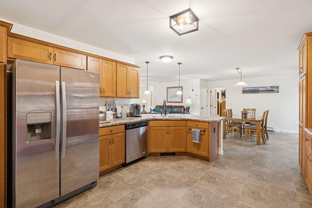 31 Knight Way N, Yarmouth, ME 04097 - kitchen with stainless steel appliances, a peninsula, brown cabinetry, pendant lighting, and light stone countertops